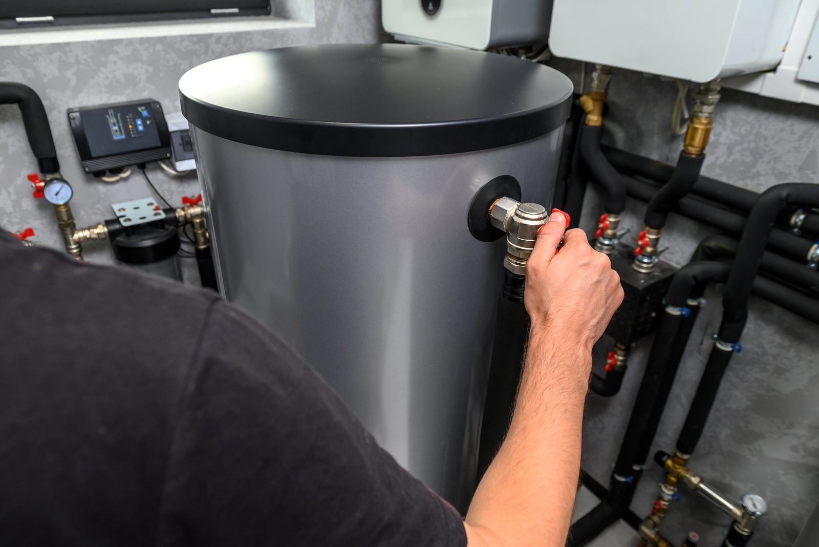 Plumber working on a water heater valve